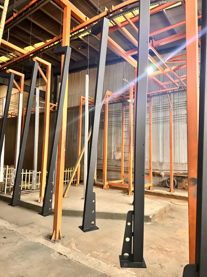 Steel court frames hanging on the powder coating line