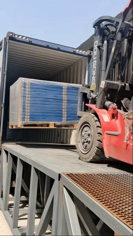Forklift loading wrapped padel court components into a shipping container